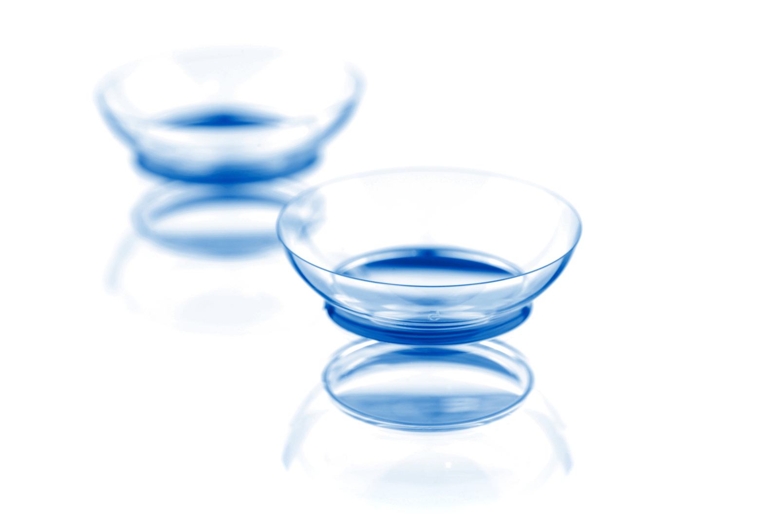 Two contact lenses with reflections, isolated on a white background